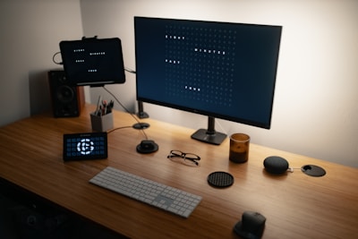 black flat screen computer monitor on brown wooden desk