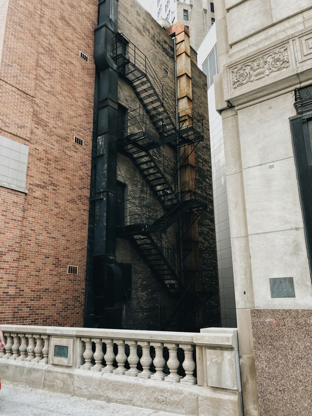 black wooden fence on brown brick building