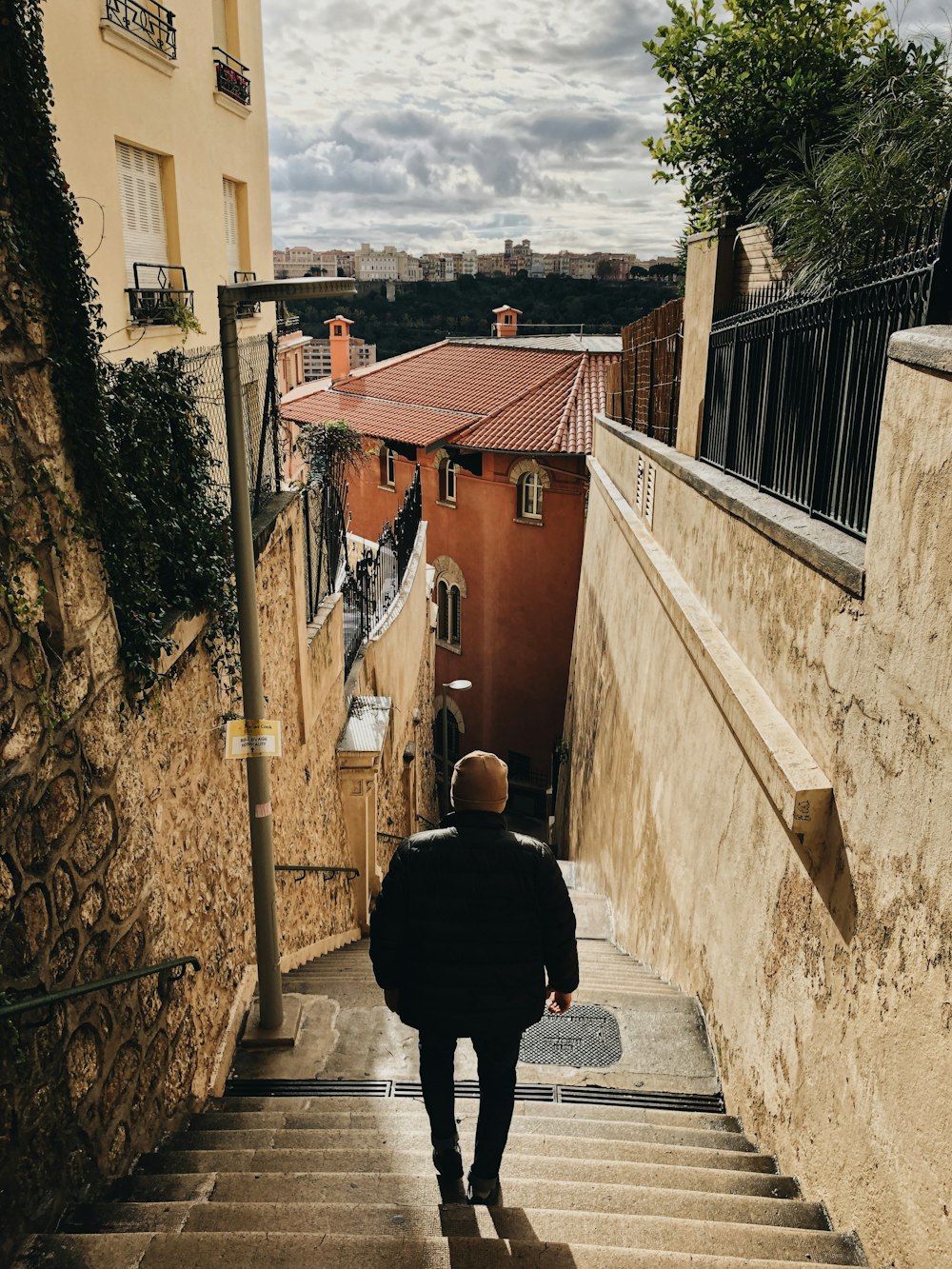 man in black jacket walking on street during daytime