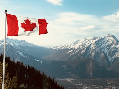 red and white flag on top of the mountain