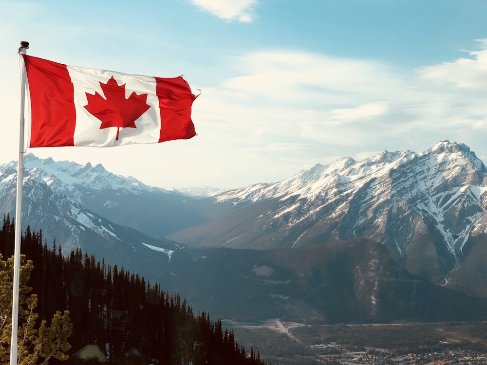 red and white flag on top of the mountain