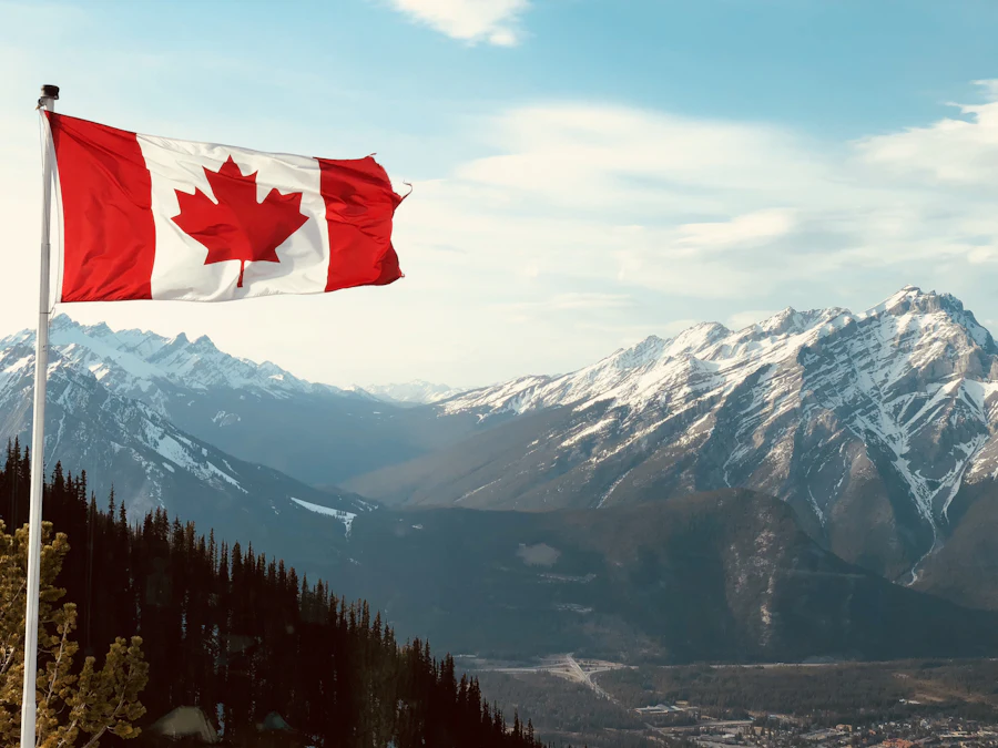 Canadian flag flying on a mountain top