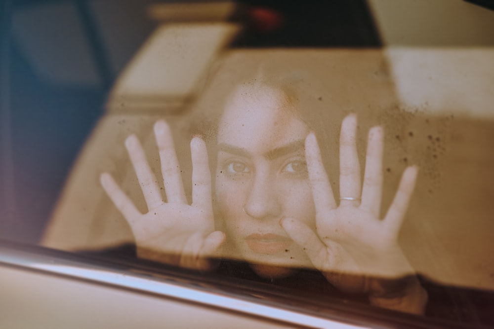 persons hand on car window