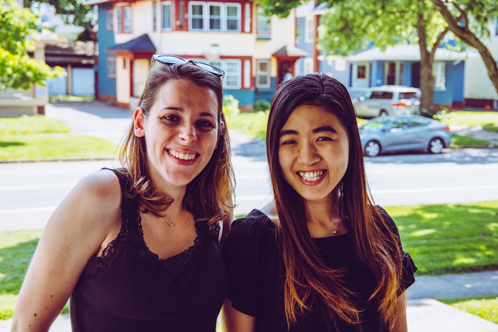 2 women smiling in front of camera