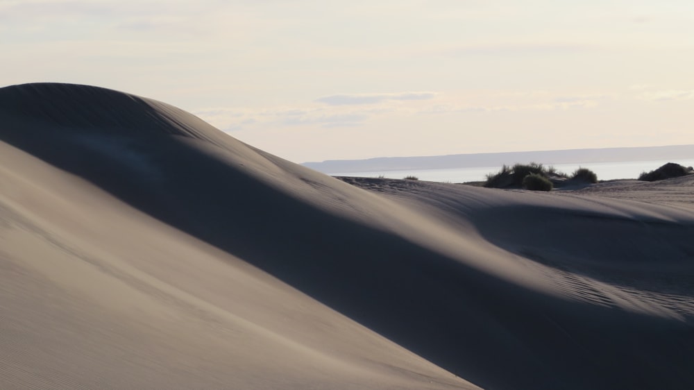 white sand under white clouds during daytime