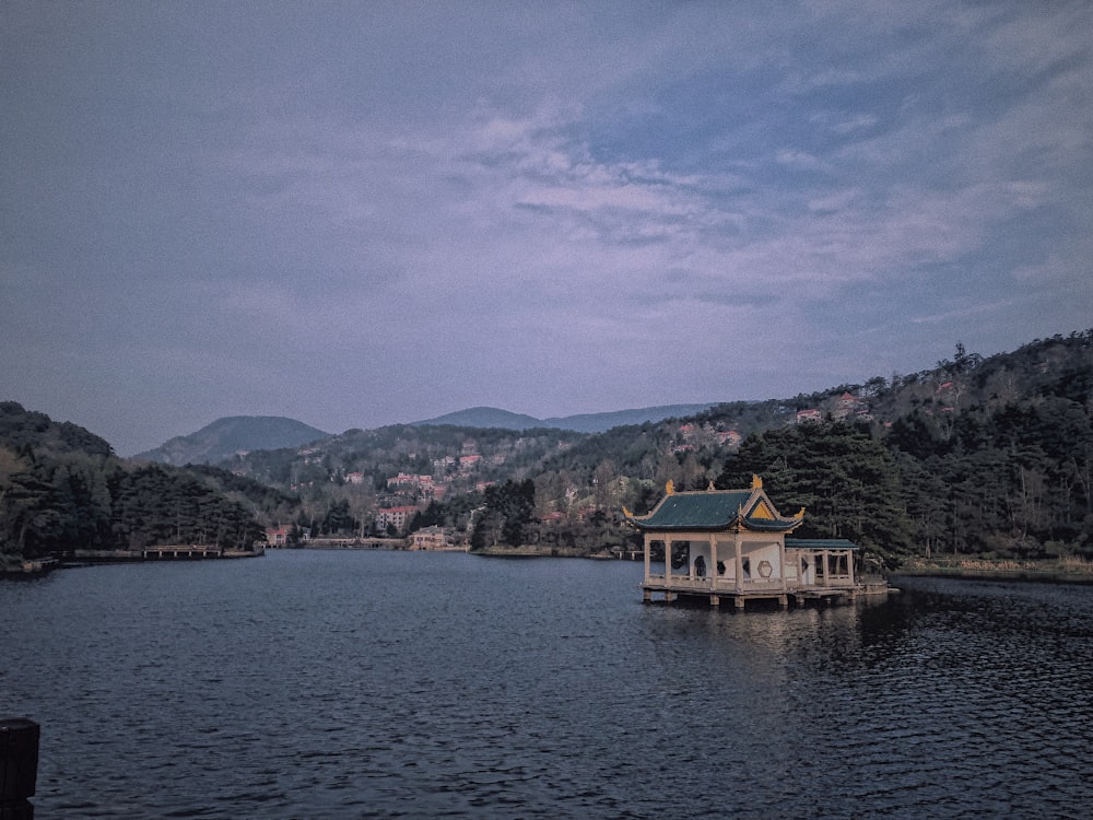 yellow and brown house near body of water during daytime