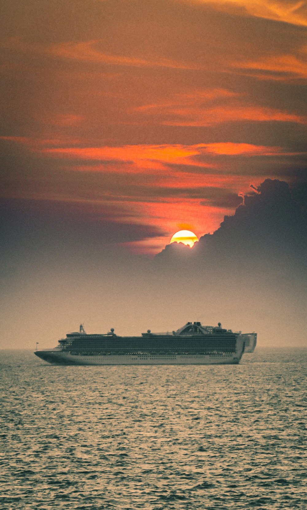 white ship on sea during sunset