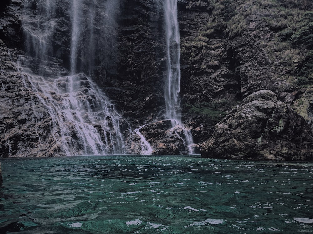 water falls in the middle of the forest