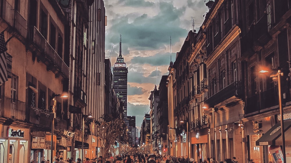 people walking on street between high rise buildings during daytime