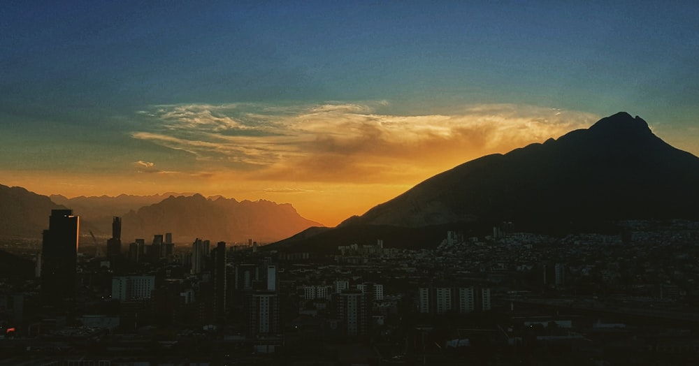 silhouette of city buildings during sunset