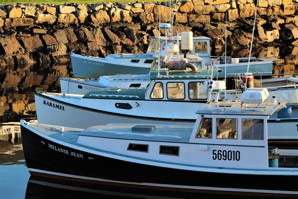 white and blue boat on body of water during daytime