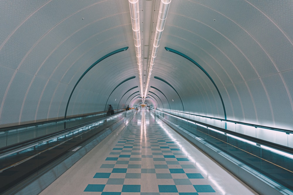 white and blue tunnel with lights