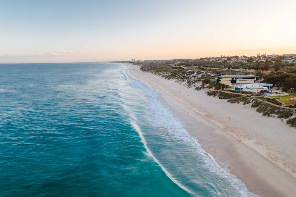 blue sea beside white sand during daytime