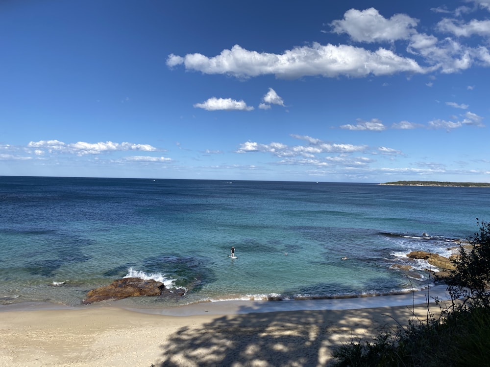 blue sea under blue sky and white clouds during daytime