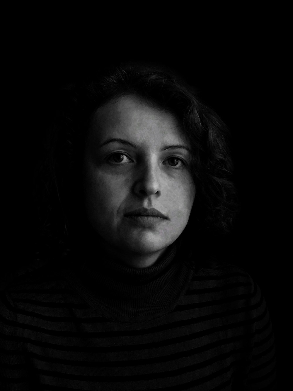 woman in turtleneck shirt in grayscale photography
