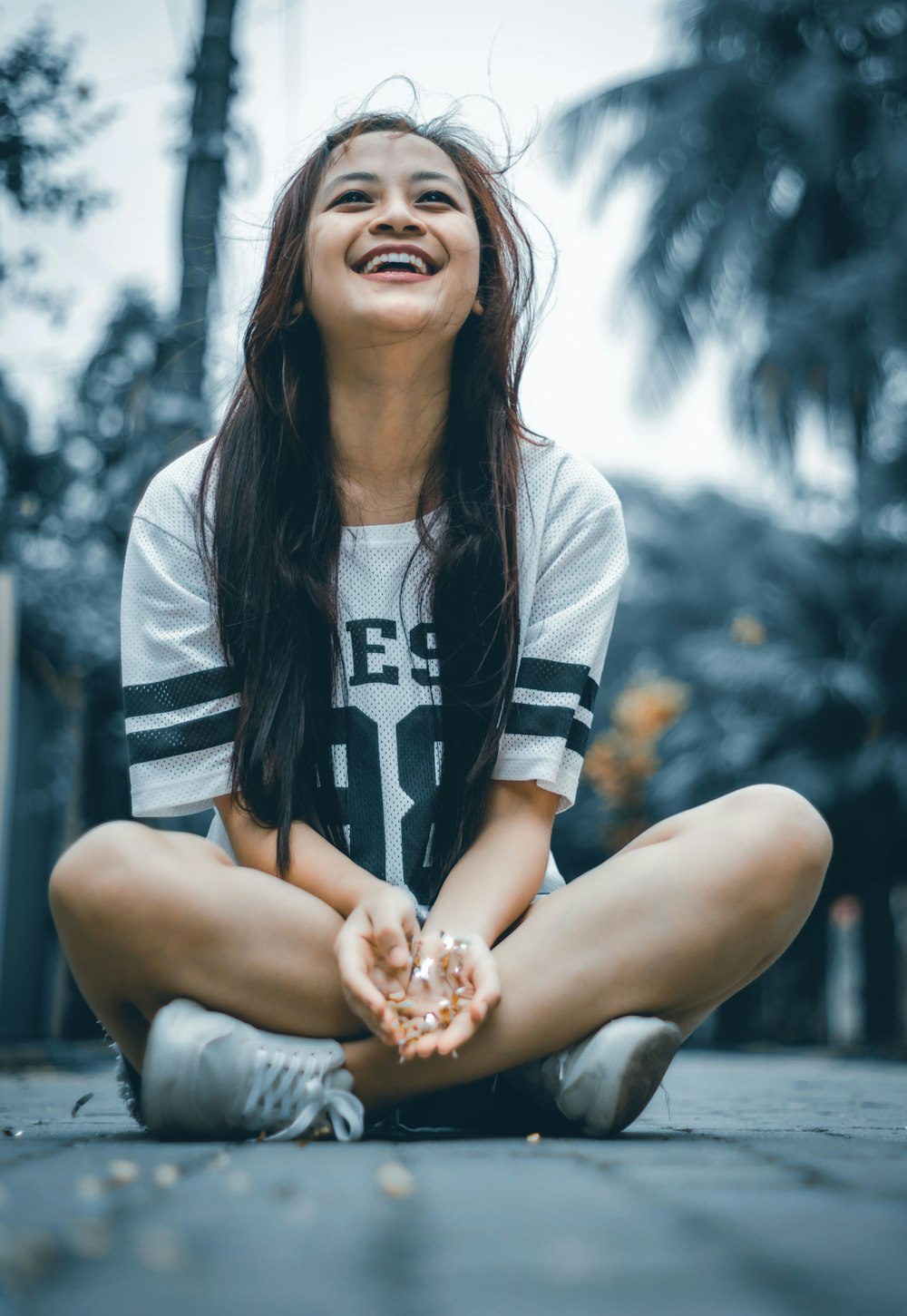 woman in black and white shirt holding brown and white food