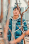 boy in gray and blue hoodie standing near white wall during daytime