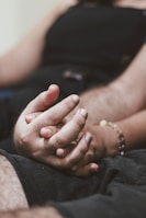 A close-up of hands intertwined, symbolizing connection.