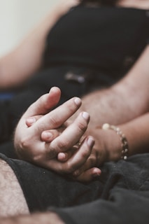 A close-up of hands intertwined, symbolizing connection and trust.