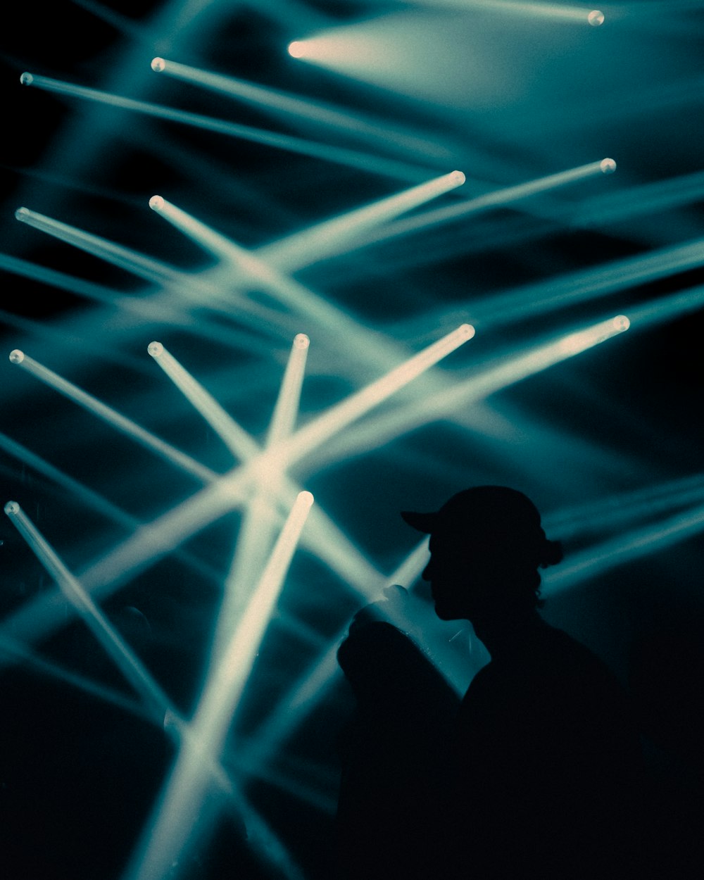 silhouette of man in front of blue light