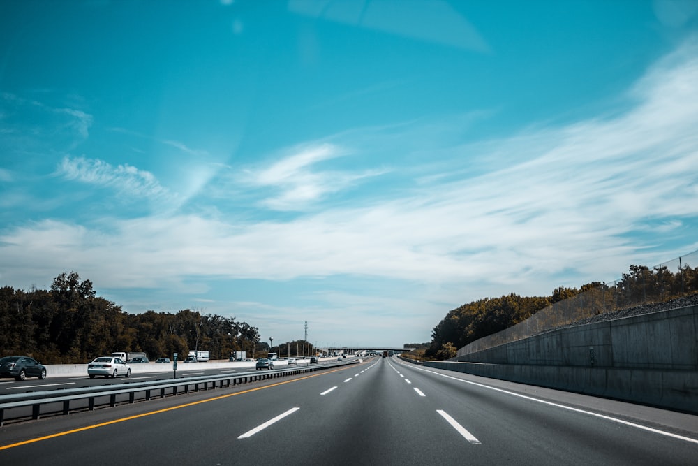 gray concrete road under blue sky