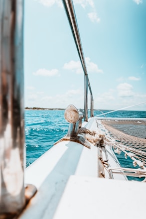 white boat on sea during daytime