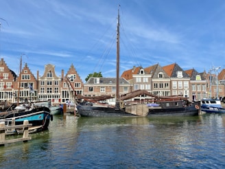 boat on dock near houses during daytime