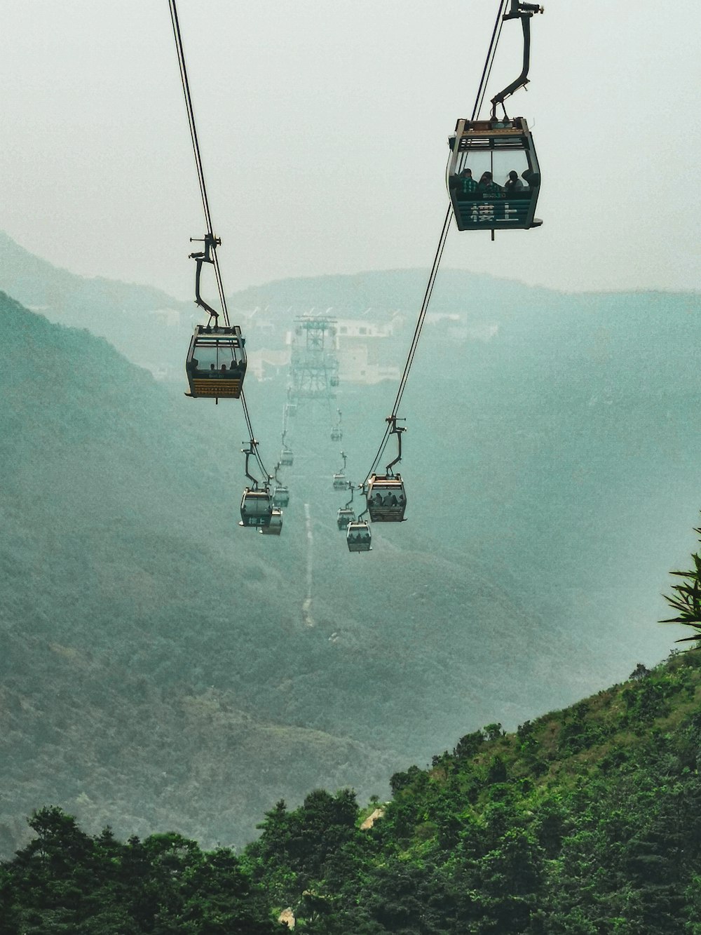 black cable car over green mountain during daytime