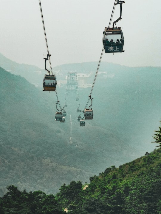 black cable car over green mountain during daytime in The Ngong Ping 360 Rescue Trail Hong Kong