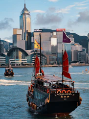 black and brown boat on water near city buildings during daytime