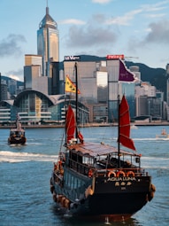 black and brown boat on water near city buildings during daytime