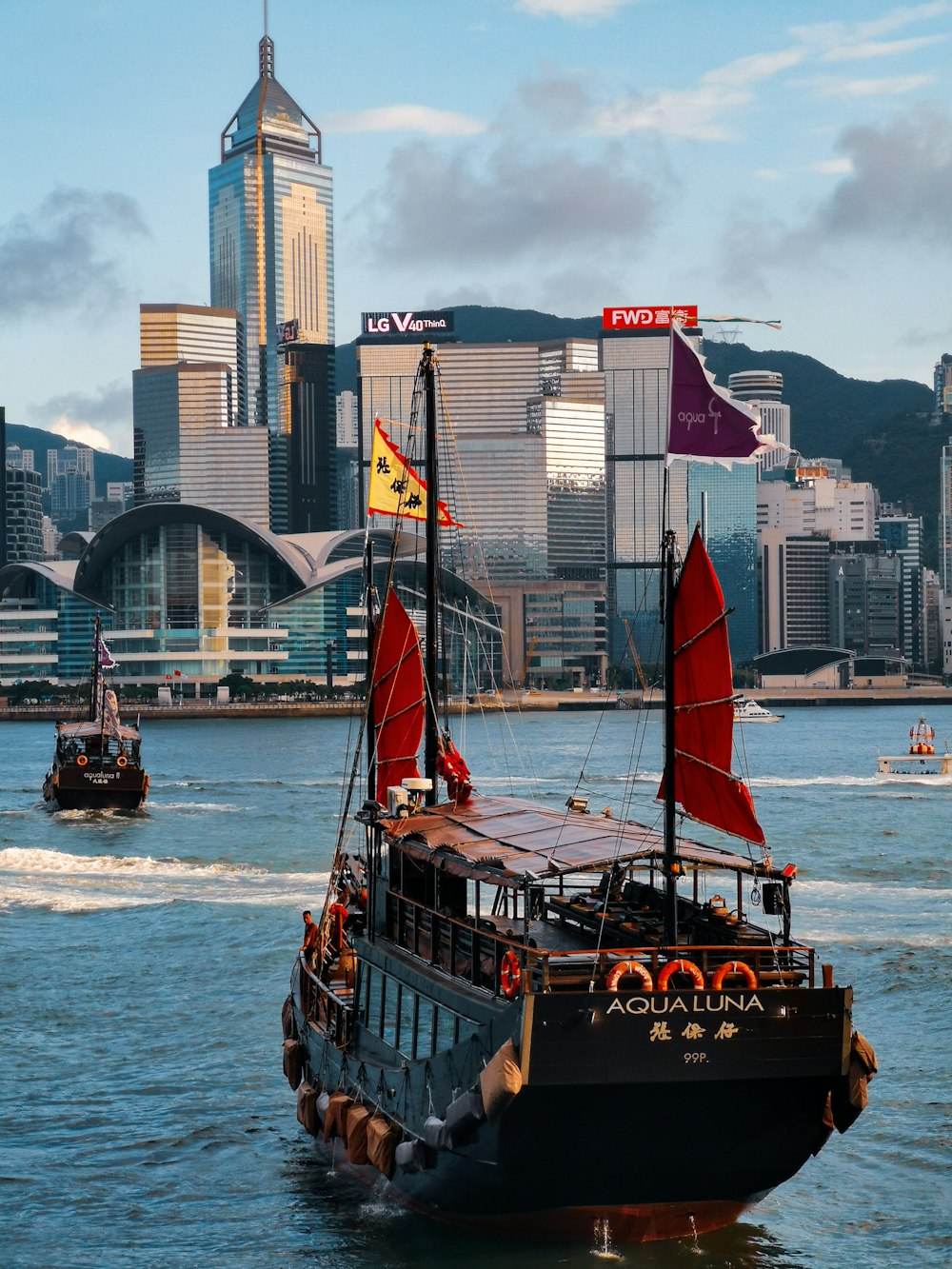 black and brown boat on water near city buildings during daytime