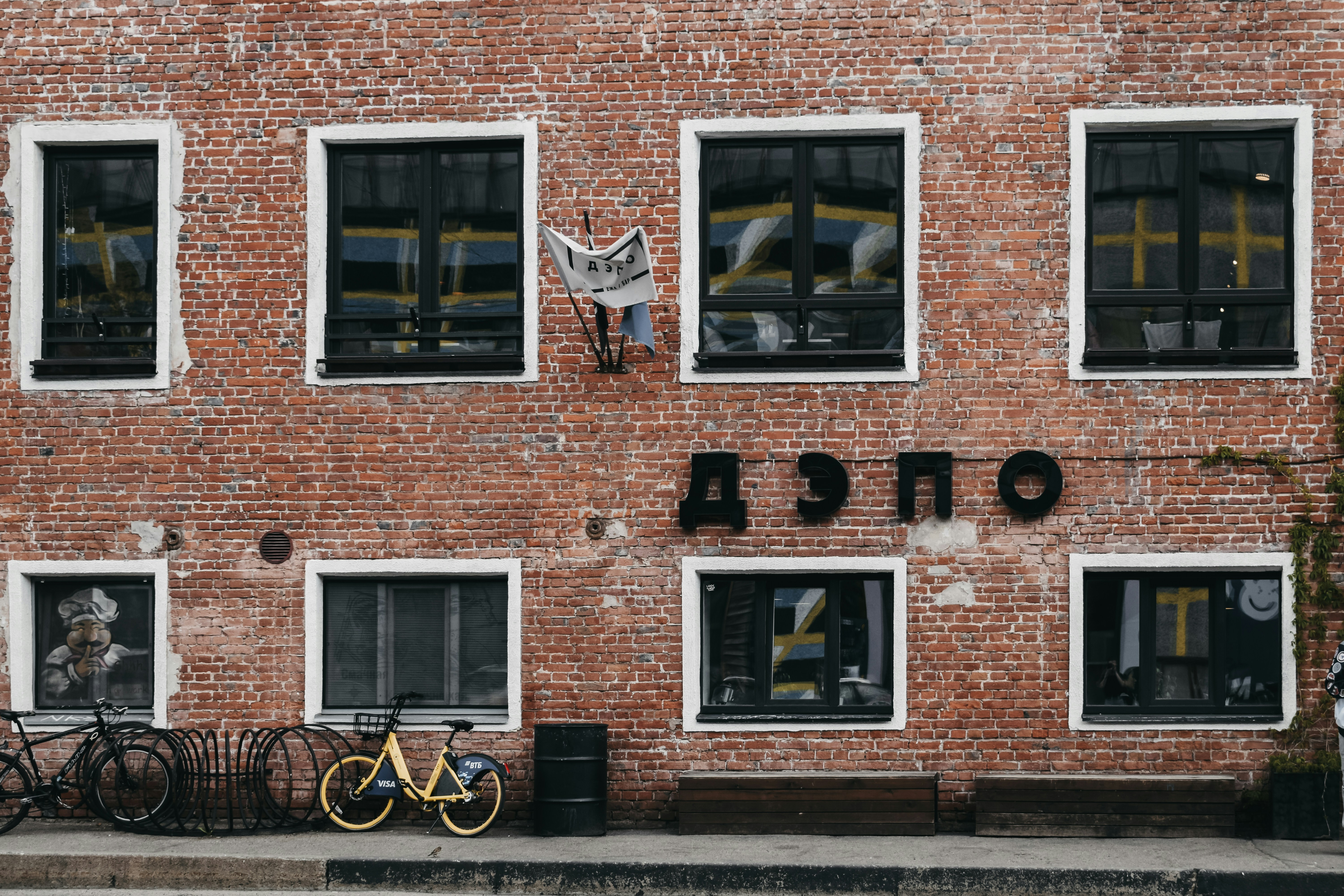 brown brick building with black framed windows