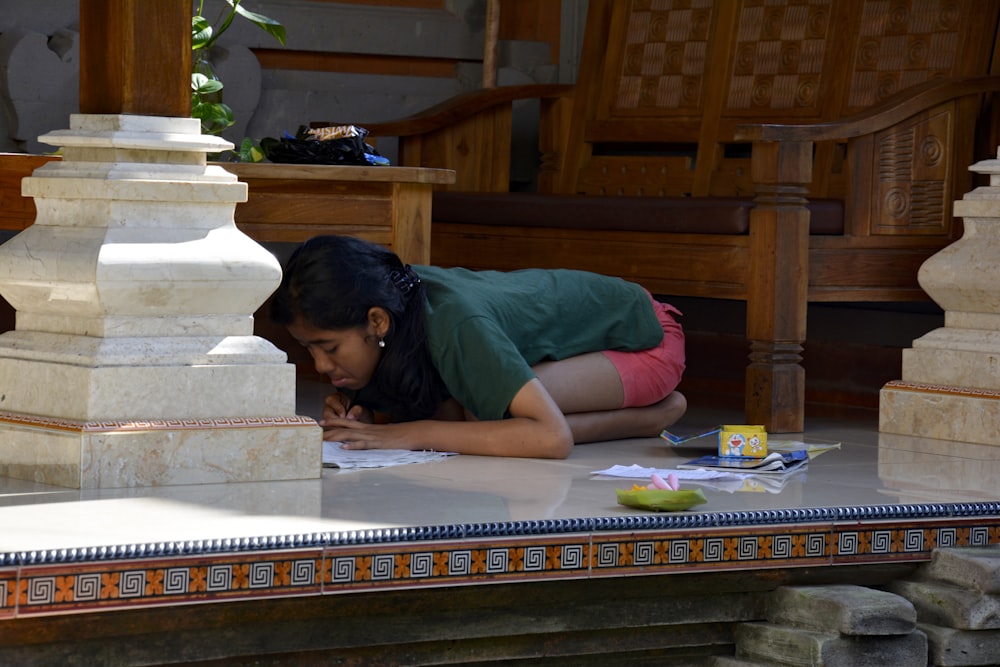 woman in green t-shirt lying on floor