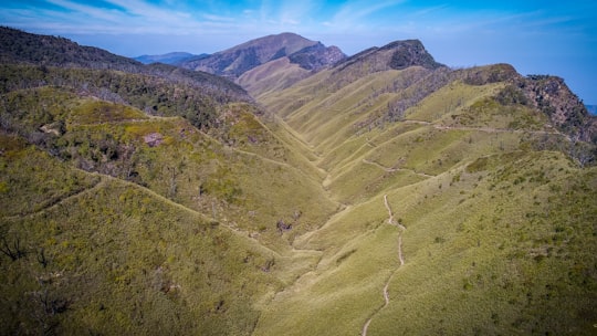 green mountains under blue sky during daytime in Nagaland India