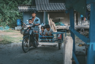 Happy family riding an ezraider with children safely seated in the back seat.