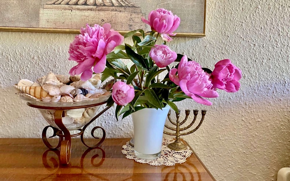 pink flowers in white ceramic vase