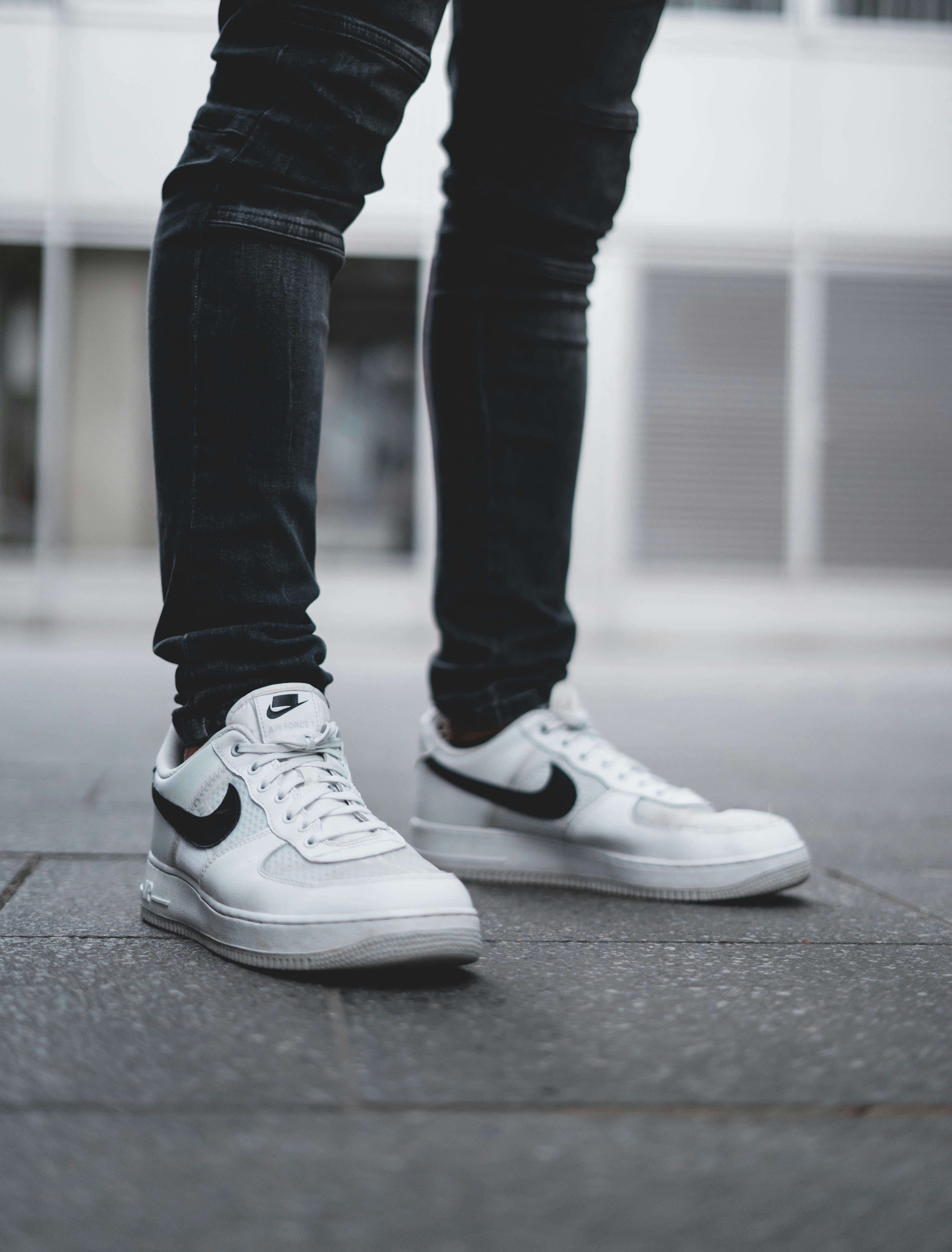 person in blue denim jeans and white nike sneakers