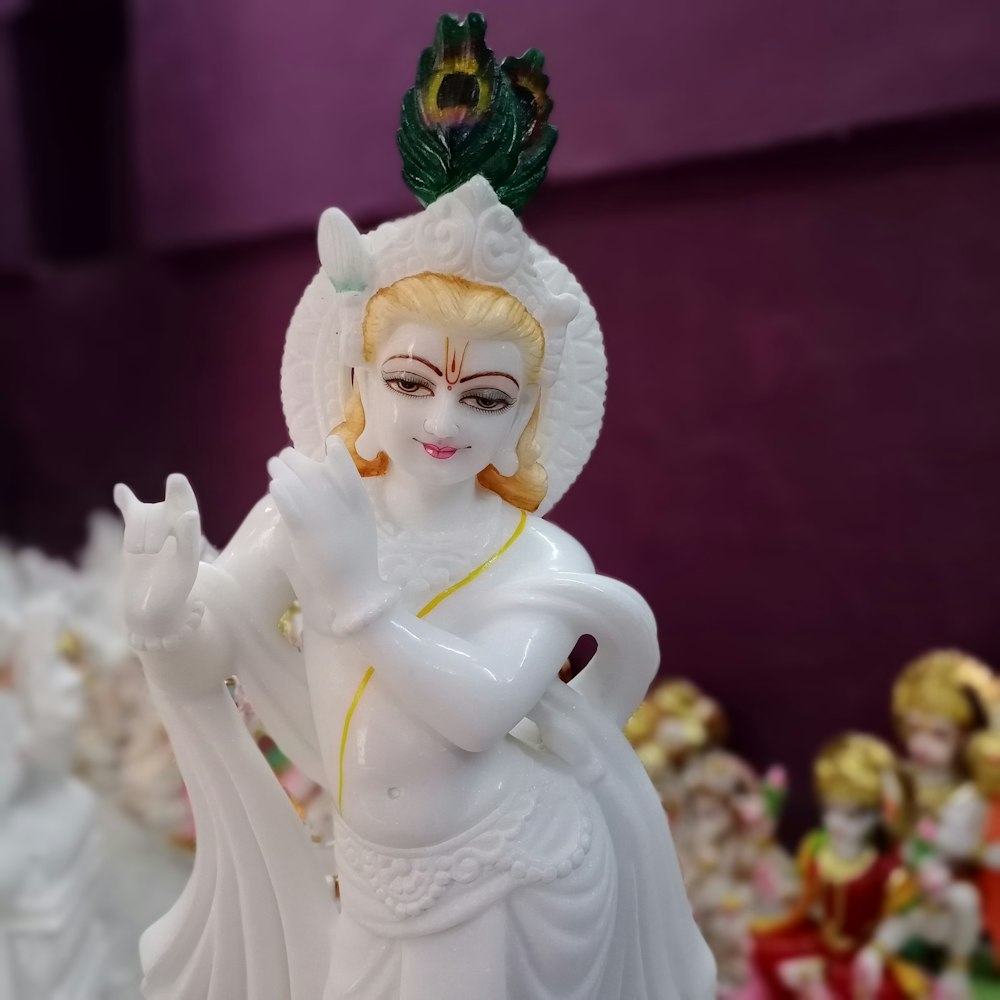 white ceramic angel figurine on table