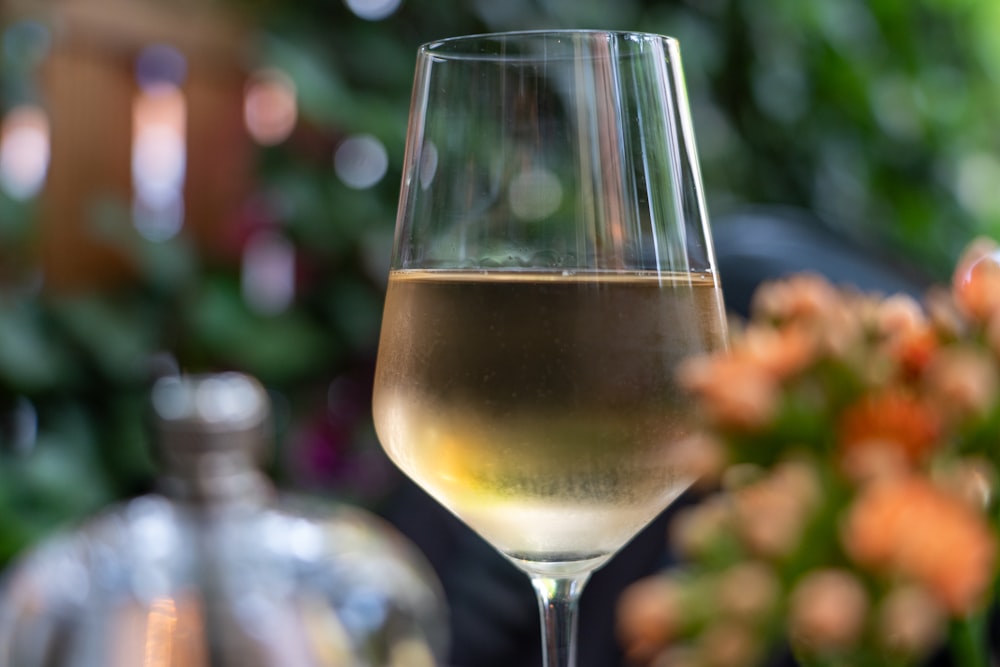 clear wine glass with yellow liquid