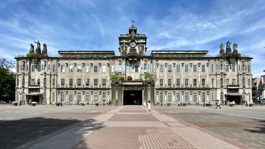 white concrete building under blue sky during daytime in University of Santo Tomas Philippines