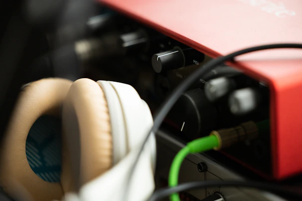 Close-up of a microphone and headphones, softly lit, capturing the intimacy of the podcast setup.