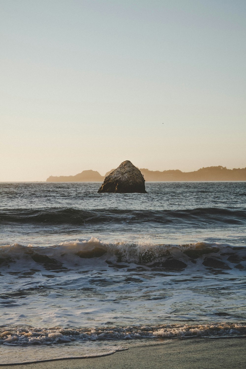 brown rock formation on sea during daytime