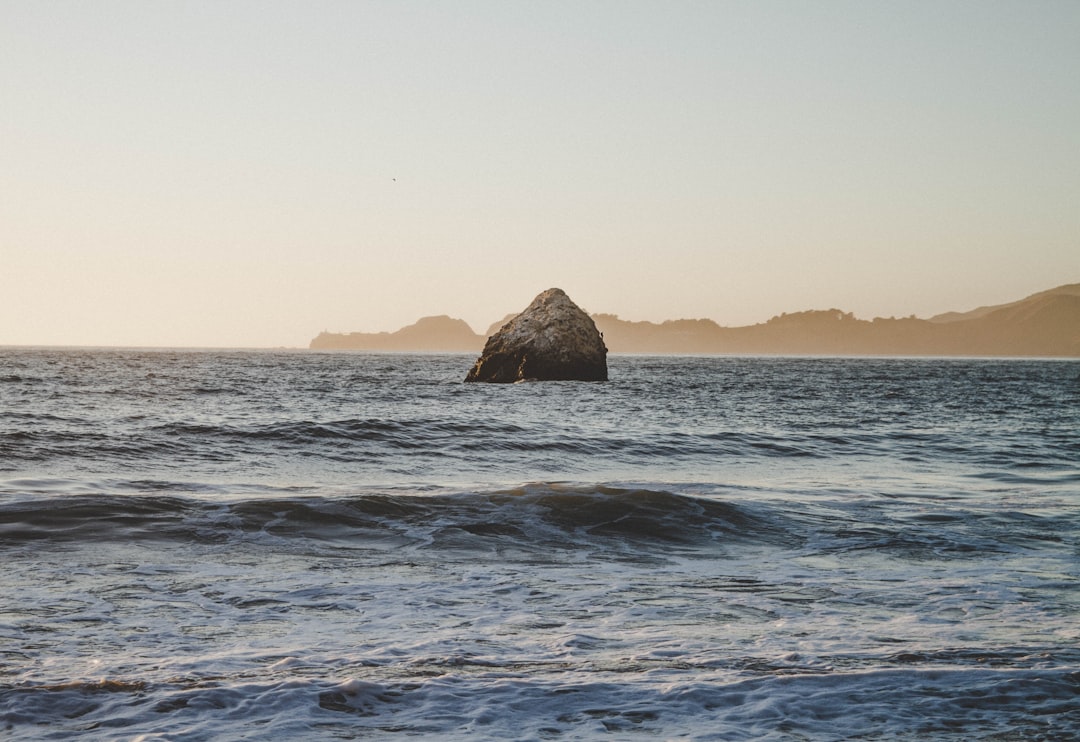 brown rock formation on sea during daytime