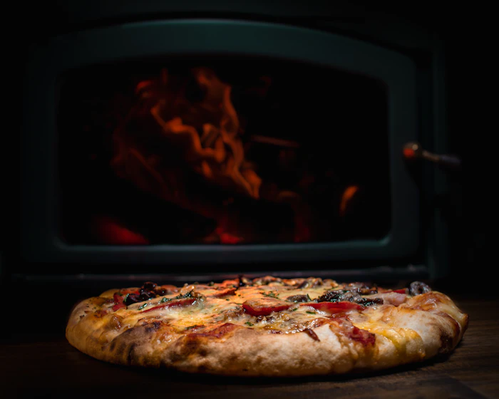 A pizza in front of the fire
