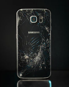 Before and after shots of a cracked screen replaced flawlessly on a smartphone.