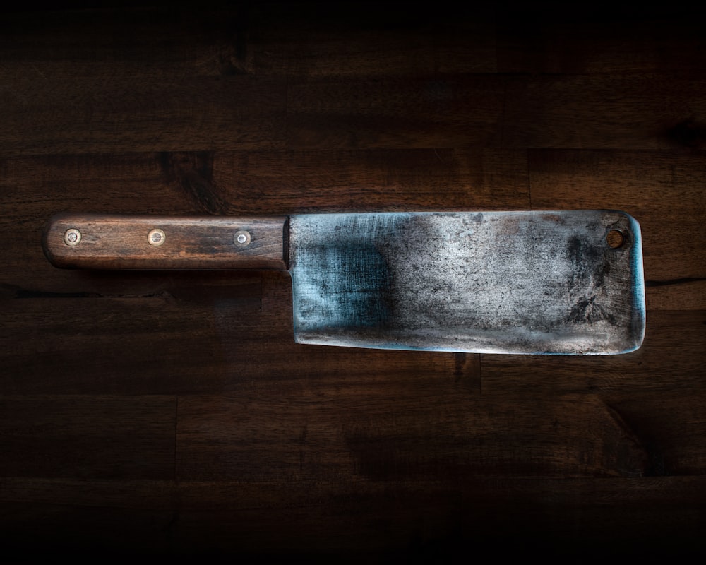 brown handle knife on brown wooden table