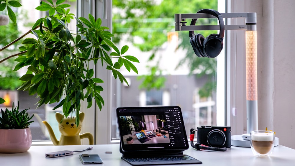 black laptop computer on white table