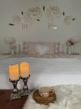 A serene home sanctuary corner featuring soft off-white textiles and subtle champagne gold decor.