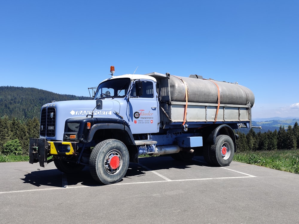 white and blue truck on road during daytime